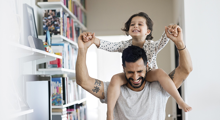 father gives daughter ride on shoulders